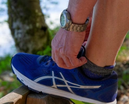 Running shoes with Medicare doctor-prescribed shoe orthotics inside