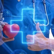 A healthcare provider holding different elements related to telemedicine