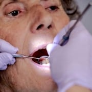 A senior woman undergoing a dental exam